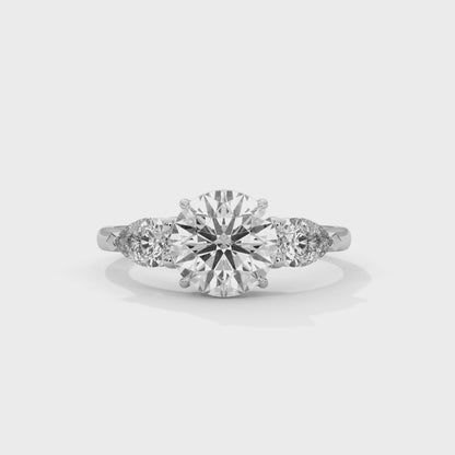 ROUND DIAMOND WITH PEAR SIDE STONE RING
